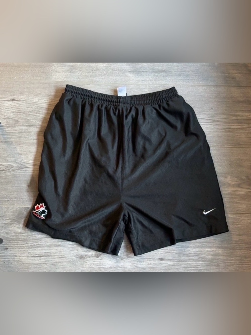 Nike Men's Black Athletic Mesh Shorts with White Swoosh